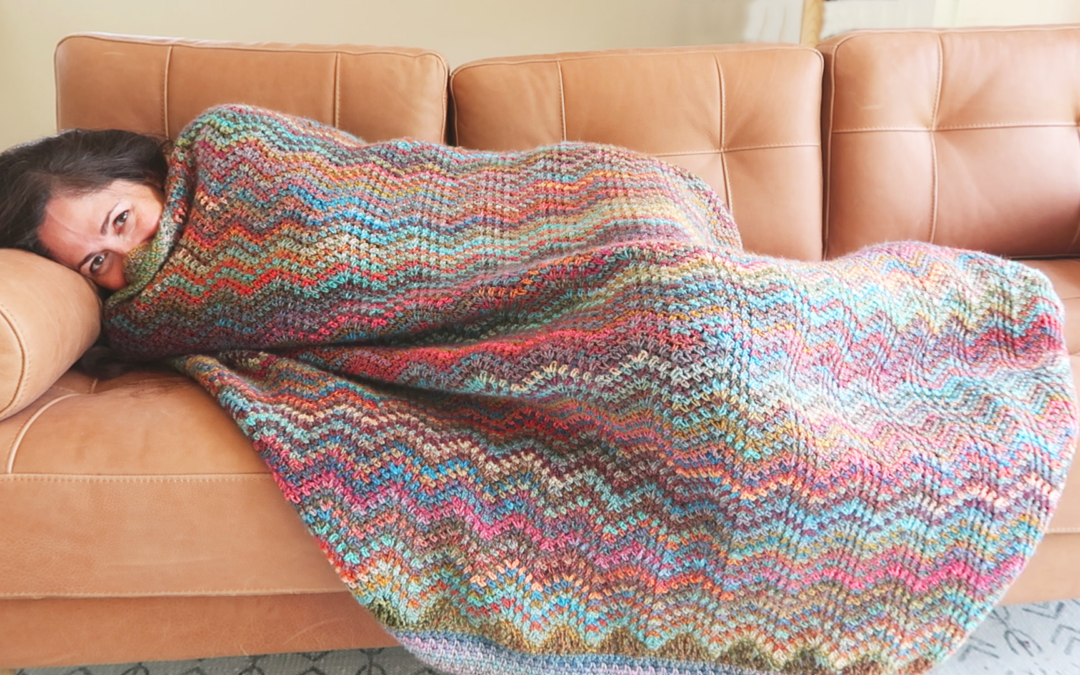 Cathy Hay under a handmade blanket with COVID